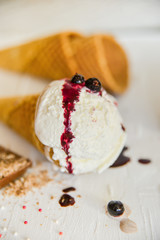 Ice-Cream Plombir In A Waffle Cup With A Topping Of Fresh Blueberries And Syrup, Grated Chocolate, Sprinkles, Overhead View.