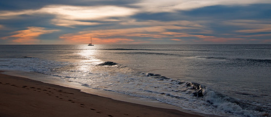 Sunrise over beach and charter fishing boat in San Jose Del Cabo in Baja California Mexico