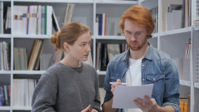 Creative Teammates Busy Doing Paperwork in Office, Discussing Project