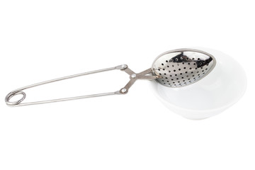 Tea strainer on a chain isolated white background.