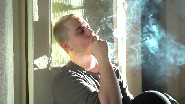 man smokes a cigarette