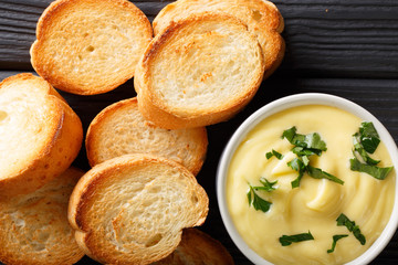 cheese dip sauce with toasted bread close-up. horizontal top view