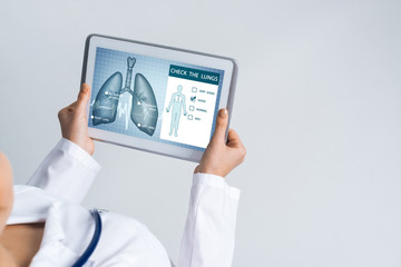 Close of female doctor hands working with tablet pc computer