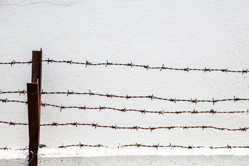 barbed wire on brick wall
