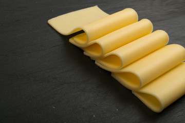 Sliced Cheese Over Stone Background