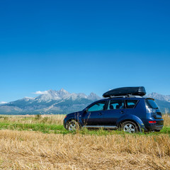 car for traveling with a roof rack on a mountain road