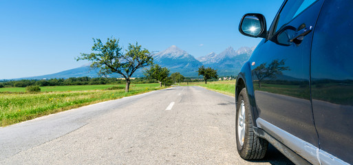 car for traveling with a roof rack on a mountain road