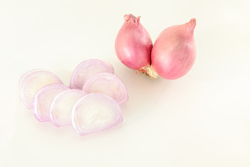 Shallots are placed on a white background.