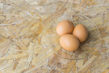 top view of eggs in bowl, egg on the table, copy space for text.