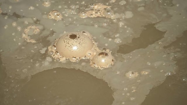 180 fps slow motion close up of bubbles on sulphur caldron in yellowstone national park, usa