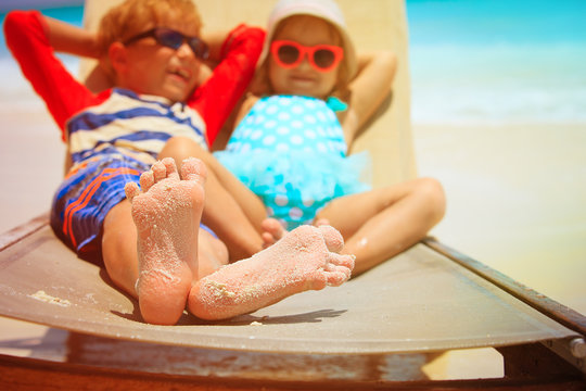happy little boy and girl relaxed on summer beach