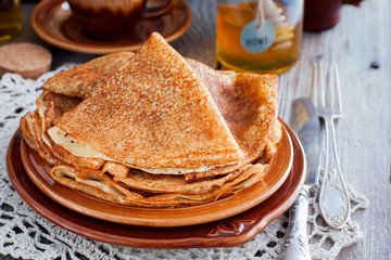 Pancakes for carnival with honey in Russian style, horizontal