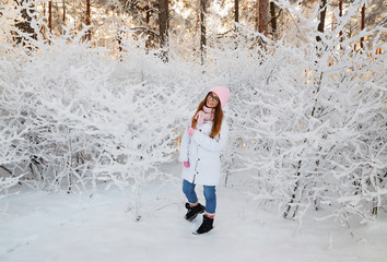 girl in winter forest with snow-covered branches of trees. fairy beauty.