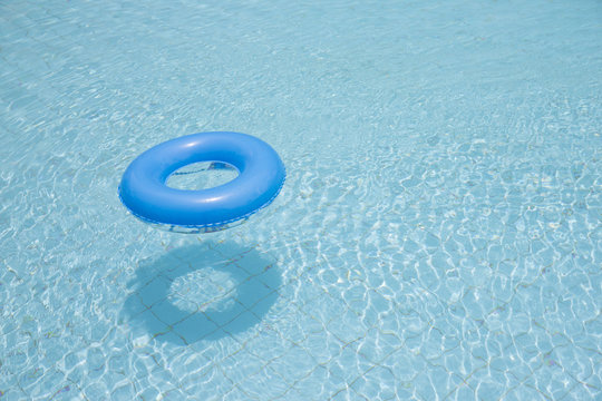 blue swim ring for children float on swimming pool isolated