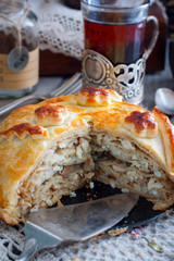 Festive national Russian pie from chicken, pancakes, rice, mushrooms. Cornice cut, selective focus © Анна Журавлева
