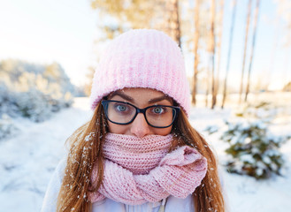 girl in glasses in the frost in snowflakes.