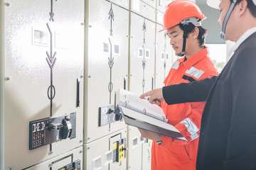 Engineers are checking the electrical system. Selective focus. Engineers and executives are...