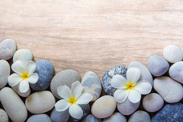 frangipani flower and stone zen spa on wood