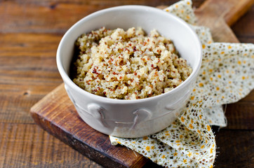 Boiled quinoa in a bowl on a wooden table