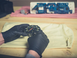 Gloved hands holding speedometer