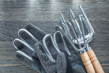 Rake trowel fork safety gloves on wooden board