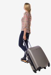 back view of walking  woman  with suitcase.