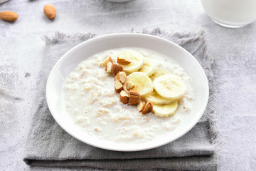 Oatmeal porridge with banana slices and nuts