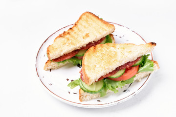 Club sandwiches with salami, tomatoes, cucumber and lettuce