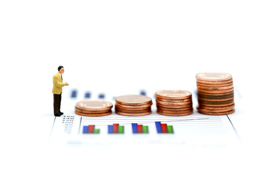 Miniature people : businessman with coins and Finance  graph background,business concept.