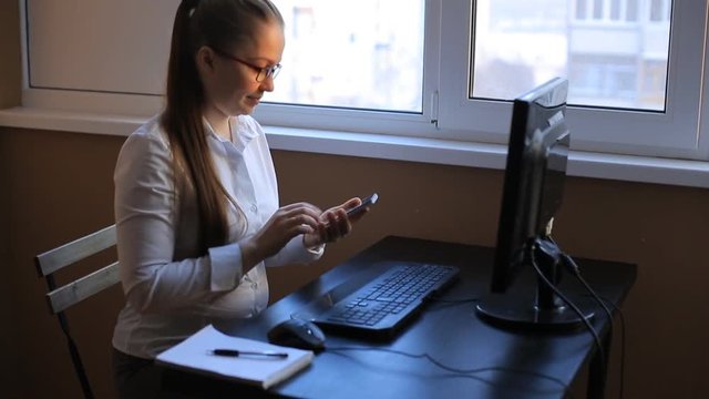 business woman works in office office computer. Compiles a financial report and scolds his employees by phone. Emotions, shouts, swears.