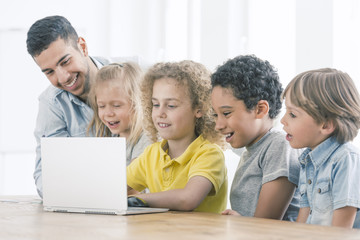 Happy kids programming on laptop © Photographee.eu