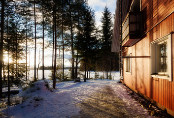 View of the winter lake under the snow and sunset
