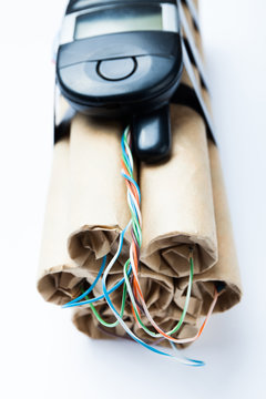 Close-up, an explosive device with a control over a mobile phone on a white background.