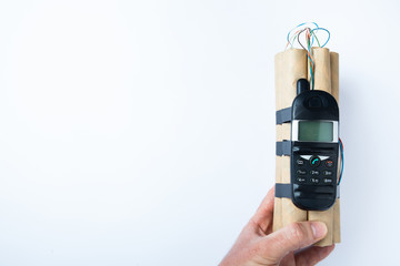 Terrorist bomb in hand on a white background. Copy space.