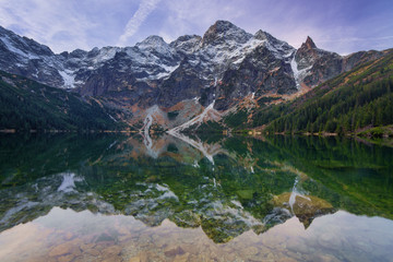 Rocky mountains reflection in the calm lake water.