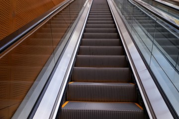 Escalators can take people one at a time.