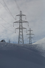 electricity pylons in winter mountains, snow