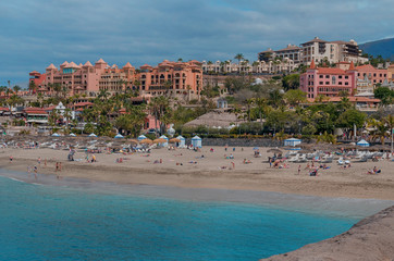Beautiful coastal view of  El Duque beach with with warm turquoise water and gold sand in Costa Adeje, Tenerife, Canary islands, Spain.