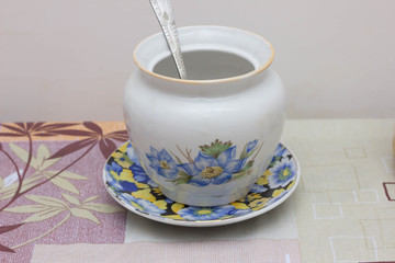 Colorful ceramic mugs with enamel look on blue wooden