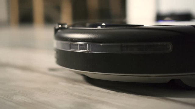 Robot vacuum cleaner on  floor, Smart robotic automate wireless cleaning technology machine. Close up Slow motion 200fps in 50p