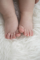 Obraz na płótnie Canvas Baby feet on blanket showing emotions. Copy space. Selective focus