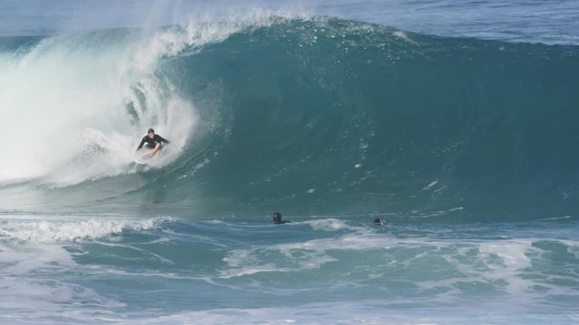 a 180p conformed to 30p slow motion shot of a water cameraman filming a surfer getting a barrel at off the wall on the north shore of oahu in hawai, usa