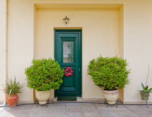 Athens Greece, cosy house entrance with green door and plants
