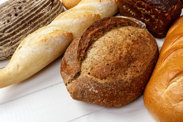 assorted of bread on white wooden background