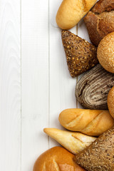 assorted of bread on white wooden background