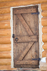 wooden door of a log house close-up. Construction