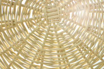 Rattan Basket. Wallpaper texture of a wicker basket with sun rays. Summer holidays concept background.