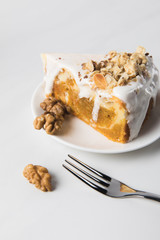Closeup of cake on plate with walnuts around