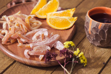 candied tropic fruits on wooden table 