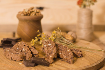 bread with candied fruit, chocolate and nuts close up picture, wooden table background